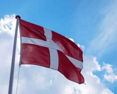 Bild einer dänischen Flagge vor einem blauen Himmel